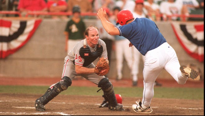 Democrat Tim Holden of Pennsylvania gets ready to tag out Republican Todd Tiahrt of Kansas before they collided at the plate in the fourth inning of the congressional baseball game in Bowie, Md., on Aug. 1, 1995.