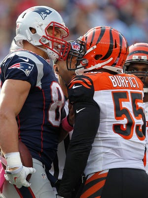 New England Patriots tight end Rob Gronkowski (87) argues with Cincinnati Bengals linebacker Vontaze Burfict (55) after the during the fourth quarter at Gillette Stadium.