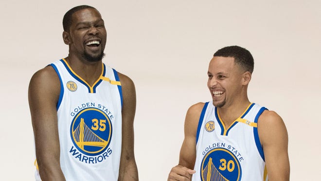 2016: Curry and Kevin Durant laugh during media day at the Warriors Practice Facility.