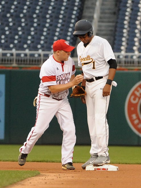 Louisiana Republican Rep. Steve Scalise tags Louisiana Democratic Rep. Cedric Richmond during the annual congressional baseball game at Nationals Park on June 23, 2016.