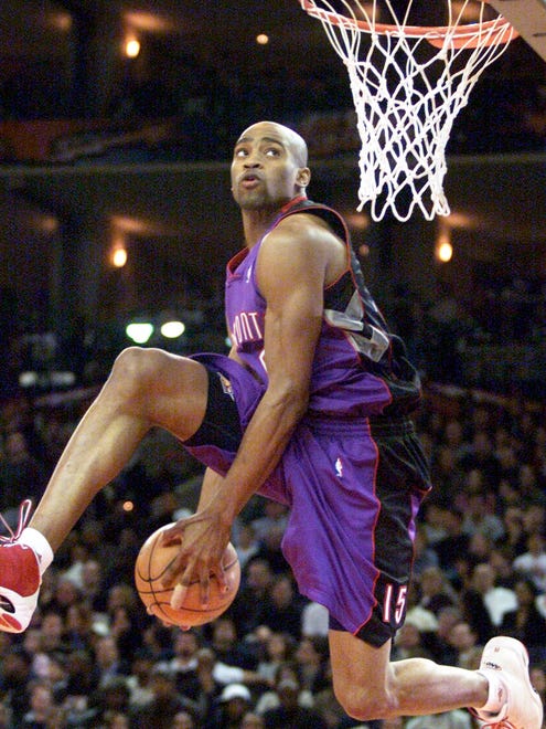 2000: Toronto's Vince Carter passes the ball between his legs as he hangs in the air during the NBA Slam Dunk Contest. Carter won the competition.