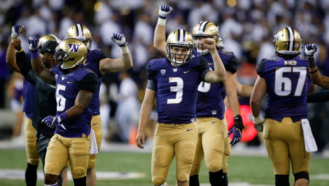 Washington players signal the start of the fourth quarter during their game against Stanford.