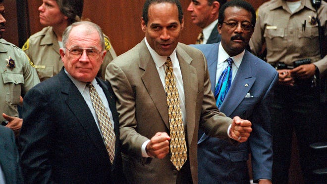 Simpson reacts as he learned he was found not guilty in 1995.