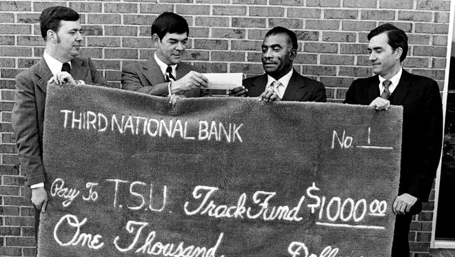 Tennessee Tufting is pushing the Tennessee State Track fund to $102,000 with this $1,000 check Oct. 27, 1976 that was printed on one of the company's rug products. From left are Robert Young, Robert Miller, TSU coach Ed Temple and Bob Meyer, of Third National Bank, which heading the public drive for the funds.