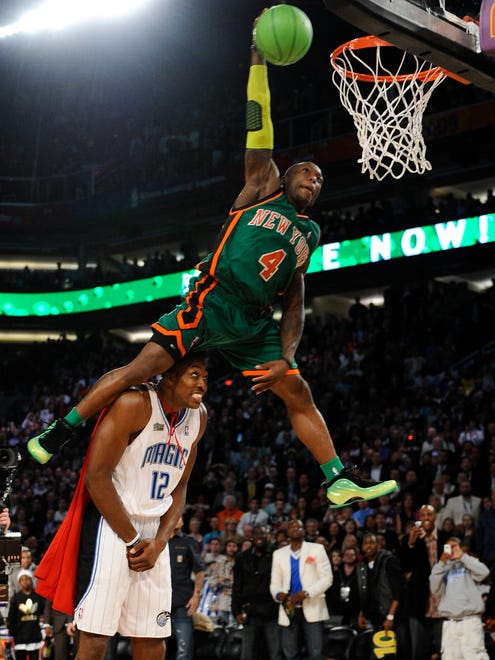 2009: Nate Robinson leaps over Dwight Howard en route to his second Slam Dunk Contest victory.