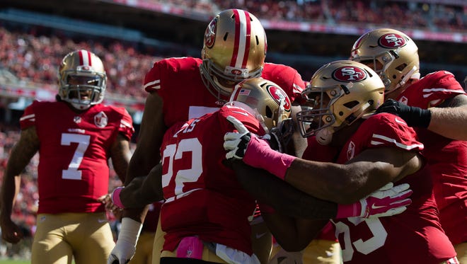San Francisco 49ers running back Mike Davis celebrates with teammates after scoring a touchdown against the Tampa Bay Buccaneers during the first quarter.