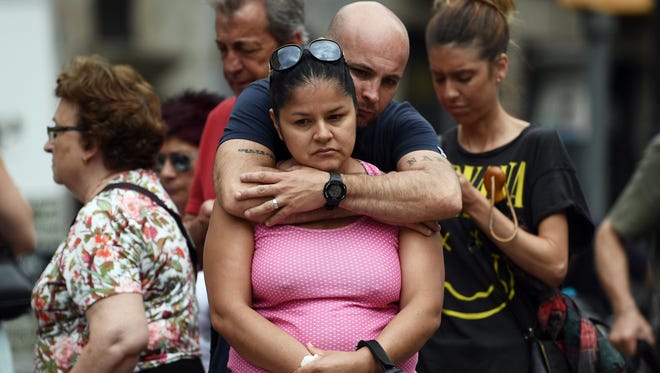 A couple embrace as they gather around tributes on Las Ramblas near the scene of Thursday's terrorist attack, on Aug. 19, 2017 in Barcelona, Spain. A nationwide manhunt continues for Younes Abouyaaqoub, now named by Spanish media as the suspected driver in an attack that left thirteen people dead and dozens injured when a van was driven at crowds in the popular Las Ramblas area of Barcelona on Thursday.