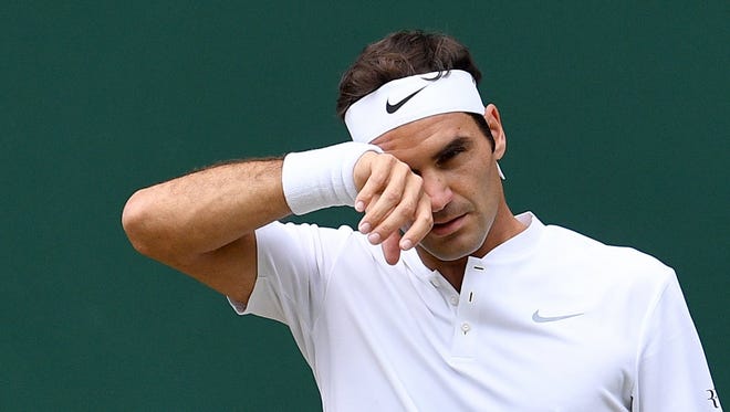 Roger Federer wipes his brow.