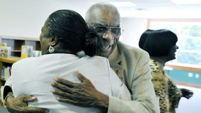 Coach Ed Temple hugs one of the former Olympic Tennessee State University Tigerbelles during their visit to New Hope Academy in Franklin August 27, 2010.