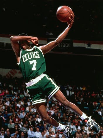 1991: Dee Brown goes up for a no-look slam dunk during the Slam Dunk Contest in Charlotte. Brown would win the contest that year.