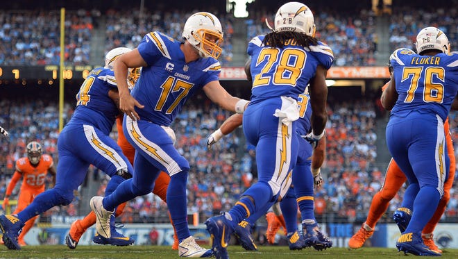 San Diego Chargers quarterback Philip Rivers (17) hands off to running back Melvin Gordon (28) during the first quarter against the Denver Broncos at Qualcomm Stadium.