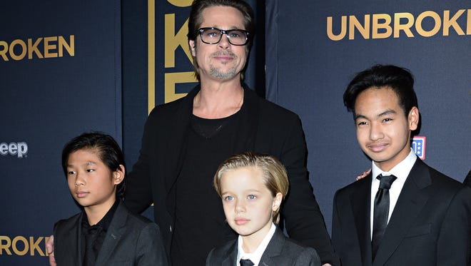 Brad Pitt with three of his children, Pax, Shiloh and Maddox, at premiere of 'Unbroken' in Hollywood, in December 2014.