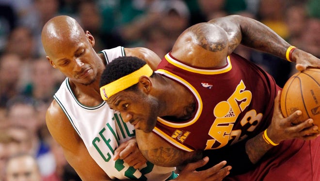 LeBron James holds the ball away from Ray Allen during the second half in Game 3 of the 2010 Eastern Conference semifinals.