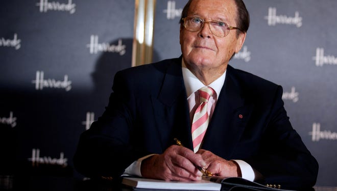 Roger Moore signs books at the launch of his book Bond on Bond,  at Harrods department store in London  Oct. 11, 2012.