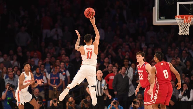 Florida's Chris Chiozza puts up the game-winning three-pointer at the buzzer to beat Wisconsin in overtime of their game in the Sweet 16 of the NCAA tournament at Madison Square Garden in New York.