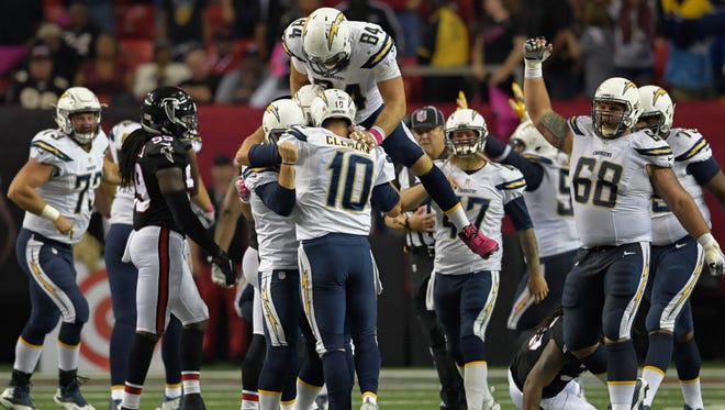 The Chargers celebrate after Josh Lambo's game-winning kick in overtime against the Falcons.