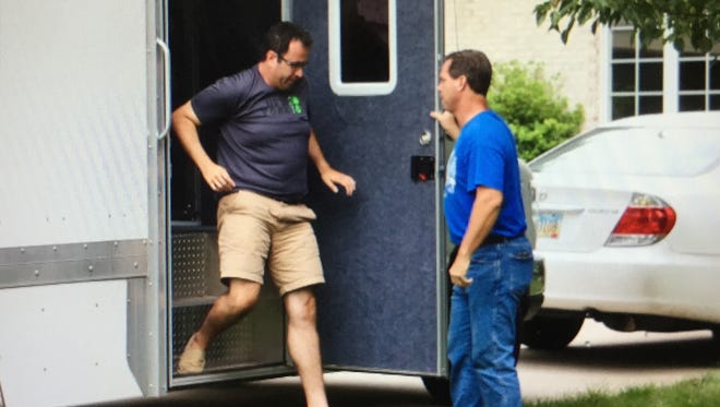 Jared Fogle, the Subway pitchman, steps from a police evidence truck parked in the drive of his Zionsville home on Tuesday.