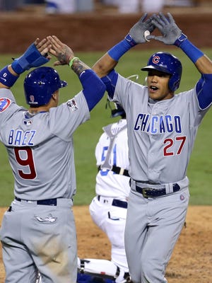 Addison Russell celebrates with Javier Baez after hitting a two-run homer in the sixth inning.
