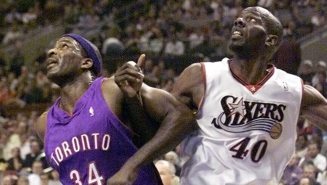 Tyrone Hill and Charles Oakley battle for a rebound as the Philadelphia 76ers host the Toronto Raptors.