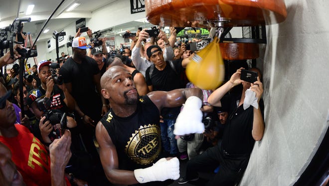 Floyd Mayweather Jr. hits a speed bag during a media workout in preparation for his fight against Conor McGregor at Mayweather Boxing Club.