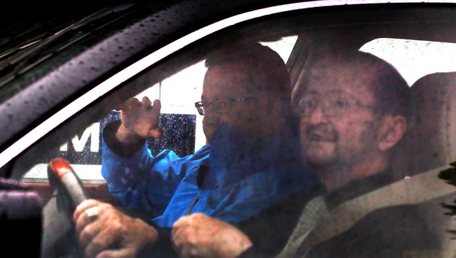Subway spokesperson Jared Fogle (left) gives attorney Ron Elberger directions out of his Austin Oaks neighborhood in Zionsville as Elberger drives him away after a morning-long criminal investigation (still ongoing) in Fogle's home in the 4500 block of Woods Edge Drive about 12:15 p.m. on Tuesday, July 7, 2015. The FBI and Indiana State Police went to Fogle's home about six hours prior, carrying multiple computer devices and media storage disks to an evidence truck parked in his driveway.