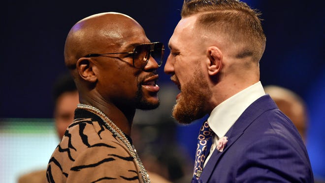 Conor McGregor and Floyd Mayweather face off during a world tour press conference to promote the upcoming Mayweather vs McGregor boxing fight at SSE Arena.