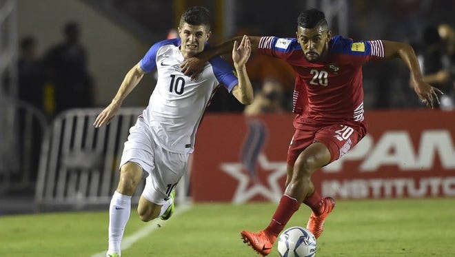 USA's Christian Pulisic and Panama's Anibal Godoy run for the ball during a World Cup qualifier in Panama City.