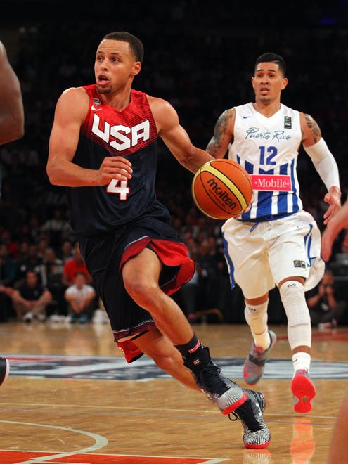2014: Stephen Curry controls the ball in front of Puerto Rico guard David Huertas.
