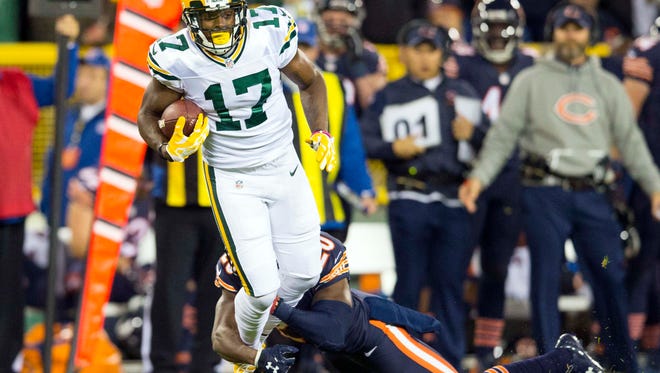 Green Bay Packers wide receiver Davante Adams (17) is tackled by Chicago Bears defensive back De'Vante Bausby (20) after catching a pass during the first quarter at Lambeau Field.