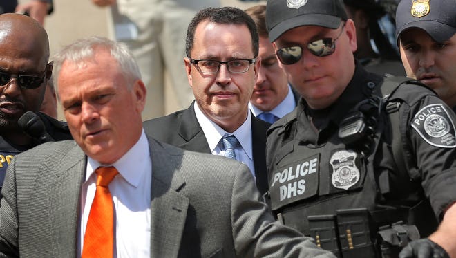 Jared Fogle, a former pitchman for Subway, is escorted to a car by police after pleading guilty on Wednesday, August 19, 2015 to charges of child pornography and having sex with minors.