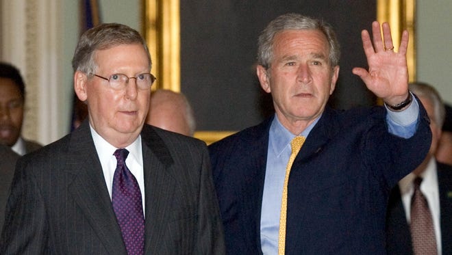 President George W. Bush walks with McConnell after he arrived at the U.S. Capitol for talks with Senate leadership on the immigration reform bill on June 12, 2007.