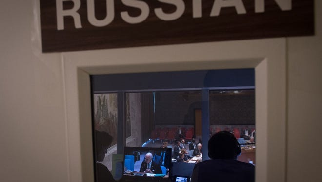 Russian translators work from a booth during a United Nations Security Council meeting on the situation in Syria, on Sept. 25 in New York.