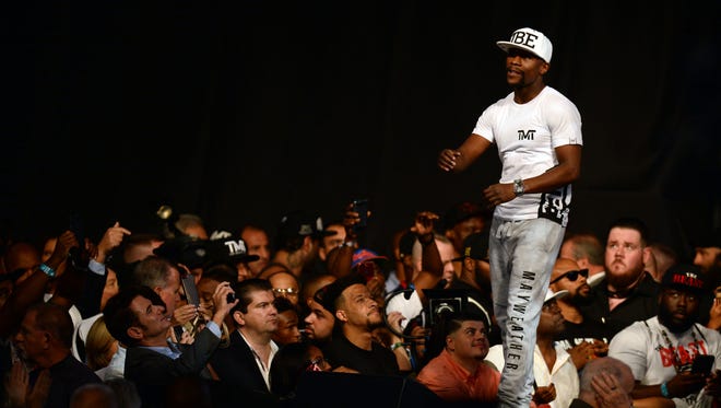 Floyd Mayweather Jr. enters the arena during weigh-ins for his upcoming boxing match against Conor McGregor (not pictured) at T-Mobile Arena.