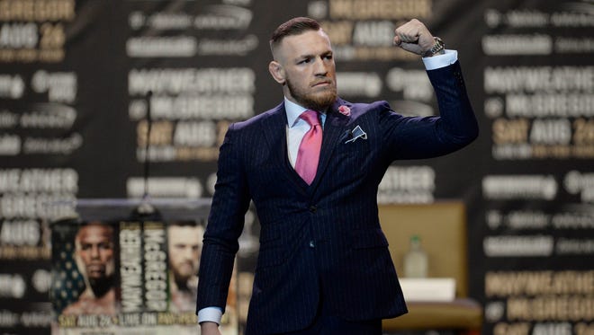 Conor McGregor arrives on stage before the world tour press conference to promote the upcoming Mayweather vs McGregor boxing match.