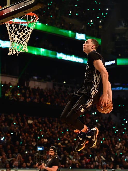 2015: Zach LaVine brings the ball behind his back, toward his knees, for a dunk during the 2015 Slam Dunk Contest in Brooklyn. LaVine would take home the title that year.