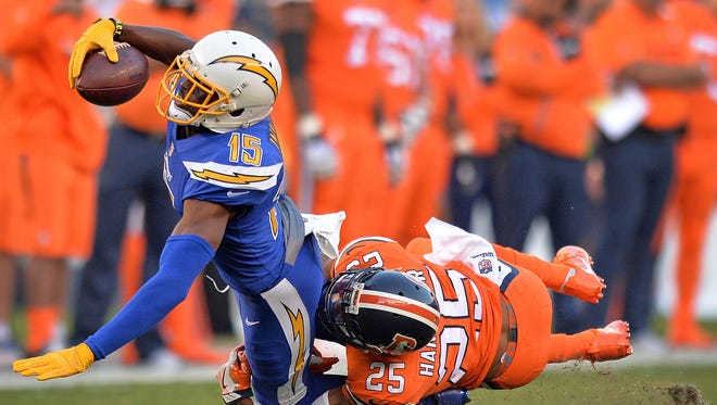 San Diego Chargers wide receiver Dontrelle Inman (15) dives forward as Denver Broncos cornerback Chris Harris (25) tackled him during the first quarter at Qualcomm Stadium.