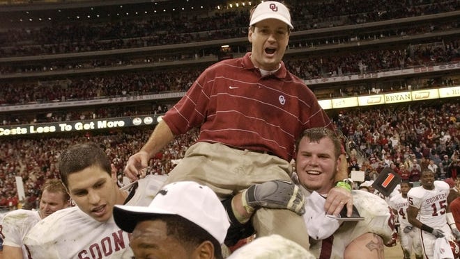 Oklahoma players carry off coach Bob Stoops after winning the Big 12 championship with a 29-7 win over Colorado in 2002.