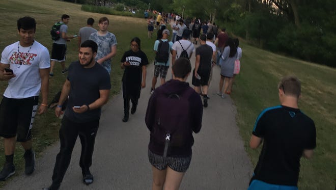 Throngs of people take to Lake Park while playing Pokémon Go in mid-July, shortly after the release of the popular smartphone game.