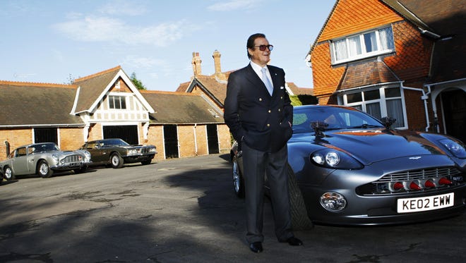 Roger Moore stands beside an Aston Martin car during a 'James Bond photocall' at Bletchley Park in Milton Keynes, United Kingdom Oct.17, 2008.