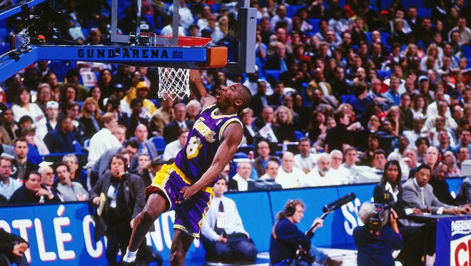 1996: Kobe Bryant attempts a one-handed dunk during the 1996 Slam Dunk Contest. He would go on to win it that year.