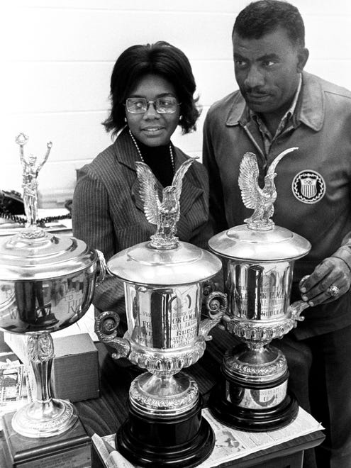 Tennessee State women's track coach Ed Temple, right, and one of the current Tigerbelle stars, hurdler Mamie Rallins, examine three trophies won by former Tigerbelle star Wilma Rudolph Oct. 26, 1971 and recently uncovered at a auction in St. Louis.