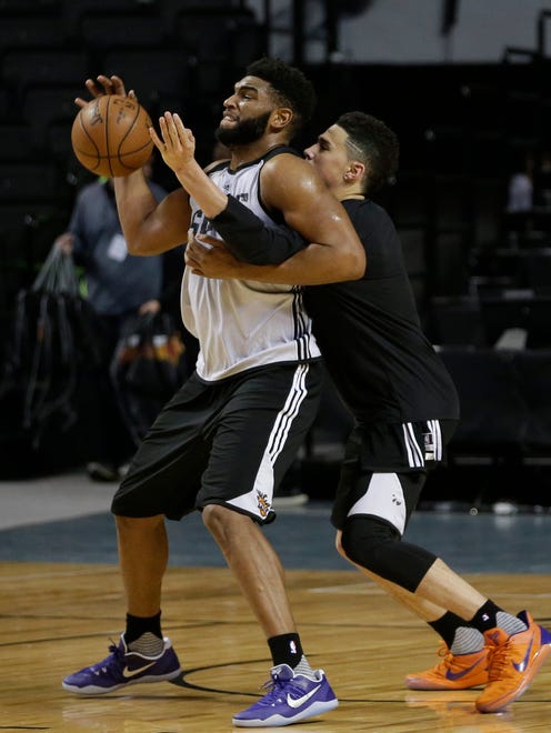 Phoenix Suns' Alan Williams and Devin Booker fight for a ball during practice the day before a game against the Dallas Mavericks at Mexico City Arena on Wednesday, Jan. 11, 2017.