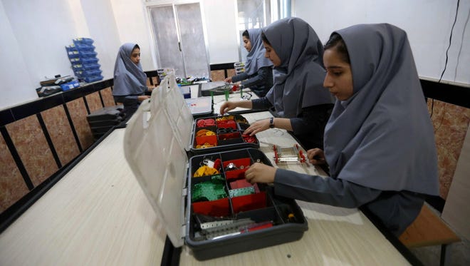 Afghan school girls work on robot machine at a school in Herat, Afghanistan on July 4, 2017. According to reports, six Afghan teenage girls have been denied visas to travel United States for an international robotics competition, but they will be permitted to send their machine designed to compete without them.