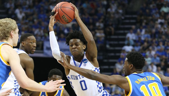 Kentucky guard De'Aaron Fox (0) drives to the basket against UCLA guard Isaac Hamilton (10) during the first half of their game in the Sweet 16 of the NCAA tournament at FedExForum in Memphis.