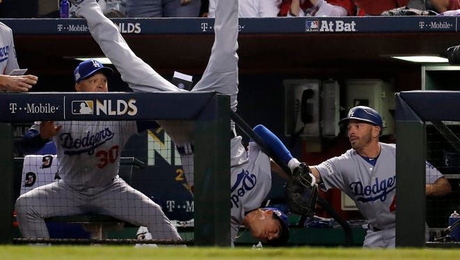 Oct. 9: Cody Bellinger falls in the dugout after catching a foul ball in the fifth inning of Game 3 of the NLDS against the Diamondbacks.