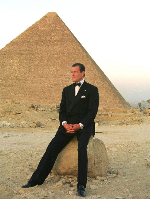 Roger Moore poses in front of Cheops, the largest of Egypt's three Pyramids on the Giza plateau south of Cairo, July 2 1999. Moore was in Egypt to promote the country's tourist attractions.