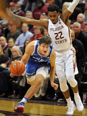 Duke Blue Devils guard Grayson Allen (3) dribbles the ball around Florida State Seminoles guard Xavier Rathan-Mayes (22) during the second half at the Donald L. Tucker Center.