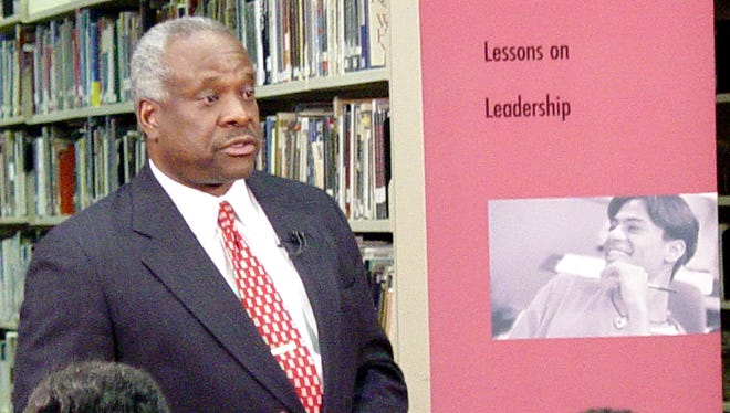 Thomas speaks to students at Benjamin Banneker High School in Washington on May 20, 2003.