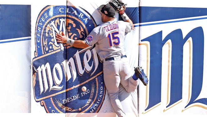 Oct. 11: Tim Tebow crashes into the outfield wall tracking down a fly ball in the fifth inning.