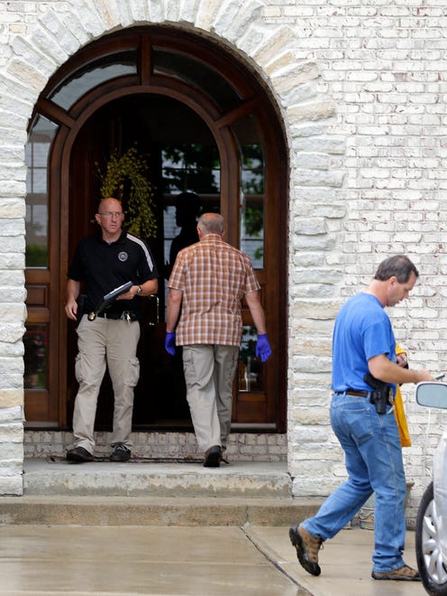 Federal authorities walk outside of  the home of Subway restaurant spokesman Jared Fogle, Tuesday, July 7, 2015, in Zionsville, Ind.  FBI agents and Indiana State Police have removed electronics from the property. FBI Special agent Wendy Osborne said Tuesday that the FBI was conducting an investigation in the Zionsville area but wouldn't confirm it involved Fogle.